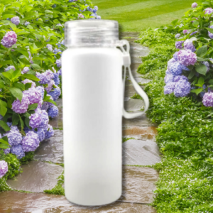 White insulated water bottle with silver lid and handle, standing on a stone garden path surrounded by purple hydrangea bushes.