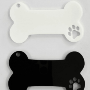 Two bone-shaped dog tags, white and black, each with a small hole for attaching a leash; paw print cutout on the right.