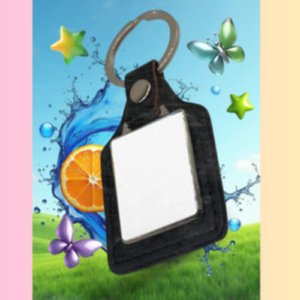 Black car key fob with a blank white tag, set against a blue sky with water splash, orange slice, stars, and a butterfly over a grassy field.