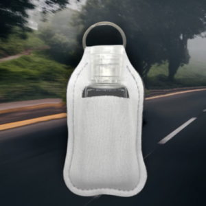 White fabric bottle carrier with a transparent bottle inside and a metal loop handle, against a blurred road background.