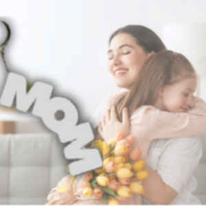 Mother and child embrace in a bright room, holding a bouquet of yellow tulips and a decorative 'mom' sign nearby.